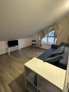 a living room with a bed and a tv at La Villa - Il Loft in Frosinone