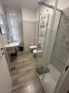 a bathroom with a shower and a toilet and a sink at La Villa - Il Loft in Frosinone