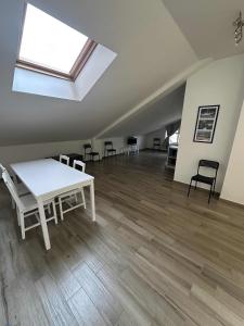 a room with a table and chairs and a skylight at La Villa - Il Loft in Frosinone