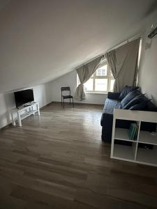 a living room with a couch and a tv at La Villa - Il Loft in Frosinone
