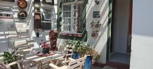 a balcony with a table and chairs on a house at Wiltshire Cottage in Port Alfred