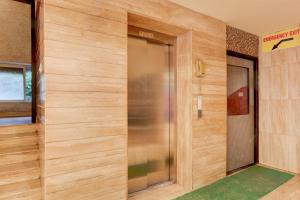 a elevator in a building with wooden walls at Super Townhouse Oak Madhapur Nera Regency in Hyderabad