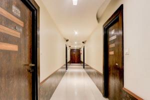 an empty corridor with a door and a hallway at Super Townhouse Oak Madhapur Nera Regency in Hyderabad +44 photos