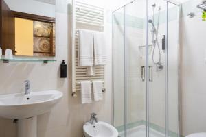 a bathroom with a sink and a glass shower at Hotel Gangi in Piazza Armerina