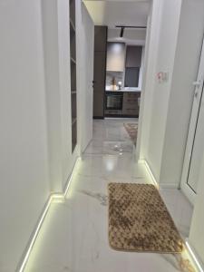 a hallway with a rug on the floor in a house at Апартамент Top Central in Yambol