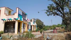 a colorful house with a red chair in front of it at Vibheeshan Villa in Yelagiri