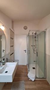 a bathroom with a shower and a white sink at L'Attico Affittacamere in Santa Maria degli Angeli +9 photos