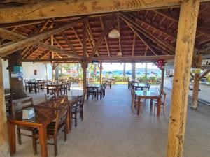 an empty restaurant with wooden tables and chairs at Nagi Beach Hotel in Gümbet