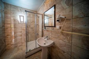 a bathroom with a sink and a shower at Nagi Beach Hotel in Gümbet +35 photos
