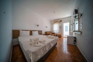 a bedroom with a large bed with white sheets at Nagi Beach Hotel in Gümbet