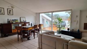 a living room with a couch and a table and chairs at L'Attico Affittacamere in Santa Maria degli Angeli