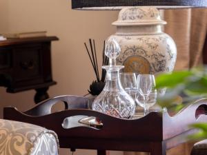 a table with wine glasses and a vase on it at Meerendal Boutique Hotel in Durbanville +37 photos