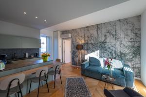 a kitchen and living room with a blue couch at Residence Moretti in Udine