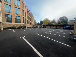 an empty parking lot in front of a building at Centennial Hotel in Cambridge