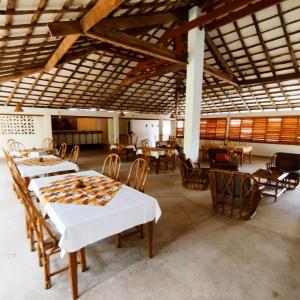 a dining room with tables and chairs in a building at BALAFON hôtel in Cap Skirring