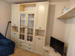 a white cabinet in a living room with a tv at Casa Milda in Capoliveri