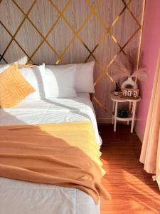a bedroom with a bed with a wooden floor at Relaxing 2BR at Camella Northpoint with balcony pool view 3rd floor in Davao City +10 photos