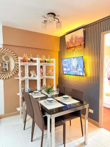 a dining room with a table and chairs at Relaxing 2BR at Camella Northpoint with balcony pool view 3rd floor in Davao City