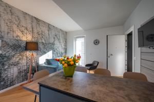 a kitchen with a table with a vase of flowers on it at Residence Moretti in Udine