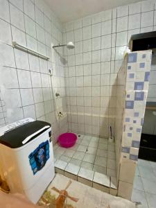 a bathroom with a toilet in a tiled floor at HIGSAM apartment in Ukunda