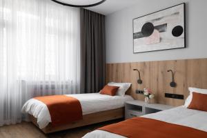 a hotel room with two beds and a window at Kibas Hotel in Bishkek +149 photos