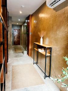 a hallway with a console table in a room at Island Pod in El Nido