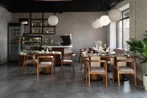 a dining room with tables and chairs and lights at Kibas Hotel in Bishkek