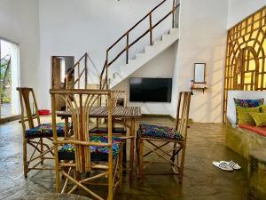 a dining room with a table and chairs at HIGSAM apartment in Ukunda