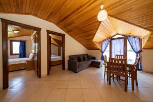 a living room with a table and a couch at Gokcen Hotel & Apartments in Oludeniz +89 photos