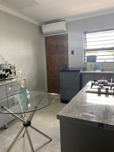 a kitchen with a glass table and a stove at Black Rose Guesthouse Northam in Northam