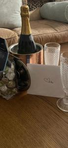 a bottle of champagne and a box of wine at Number 78 Boutique M56 Junction 12 located 5 minutes drive from Frodsham Continental breakfast Included Entire accommodation comprises of a Large double bedroom Separate lounge with sky tv Large bathroom with a free standing bath and shower in Frodsham