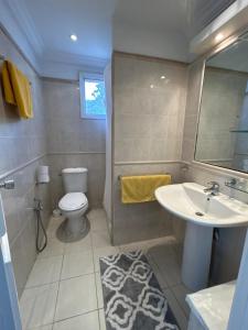 a bathroom with a toilet and a sink at Hotel Plaza la marsa in Tunis +17 photos