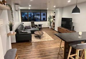 a living room with a couch and a table at Suvannee guesthouse in Ban Khlong Hua Sakae
