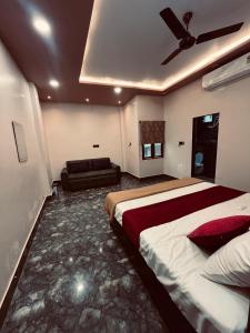 a hotel room with a bed and a couch at Awadh Kunj Palace in Ayodhya +8 photos