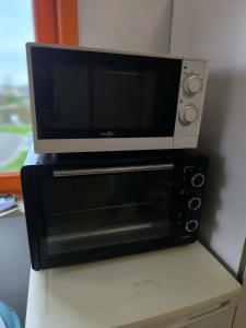 a microwave oven sitting on top of a table at Villa vague bleue Blankenberge in Blankenberge +21 photos