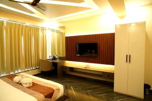 a hotel room with a bed and a desk at Tulsi Resort in Gorakhpur +12 photos