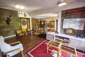 a living room with chairs and a table in a room at Villa Rock Stop Falls Gigiri in Nairobi
