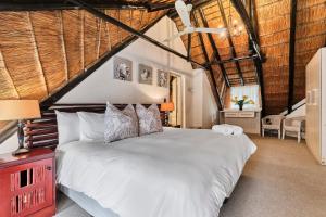 a bedroom with a large white bed in a room at Jewel On Juweel in Four Ways