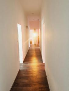 an empty hallway with white walls and wooden floors at Hotel Sickinger Hof in Berlin