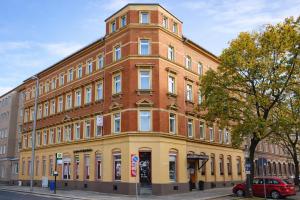 a large brick building on the corner of a street at Hotel Elisenhof in Chemnitz