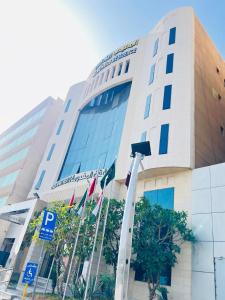 a building with flags in front of it at Al Muhaidb Residence Al Malaz 4 - Economic in Riyadh