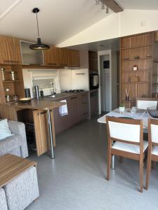a kitchen and living room with a table and chairs at Nadege in Lège-Cap-Ferret +11 photos