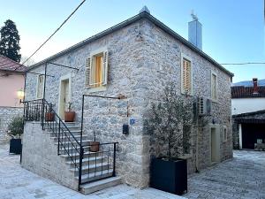 a stone house with a staircase on the side of it at Tri srca 2 - De Luxe 2 in Trebinje
