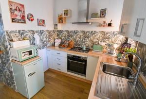 a small kitchen with a stove and a microwave at B&B Maison Glenì in Isernia +30 photos