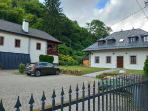 a car parked in a driveway in front of a house at Lotrinský Apartmány in Hodruša