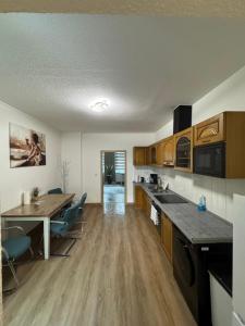 a kitchen with a table and chairs in a room at Ferienwohnung Florion 2 in Bernburg