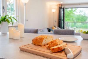a loaf of bread on a cutting board on a table at The Boathouse in Biddenden +28 photos
