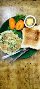 a plate of food with eggs and toast and vegetables at Lalit Heritage Home in Pātan +75 photos