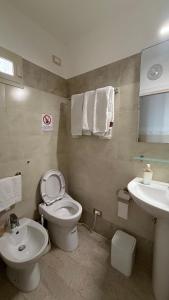a bathroom with a toilet and a sink at Albergo Cavour in Palermo