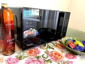 a microwave sitting on a counter next to a bowl at Tri srca 2 - De Luxe 2 in Trebinje